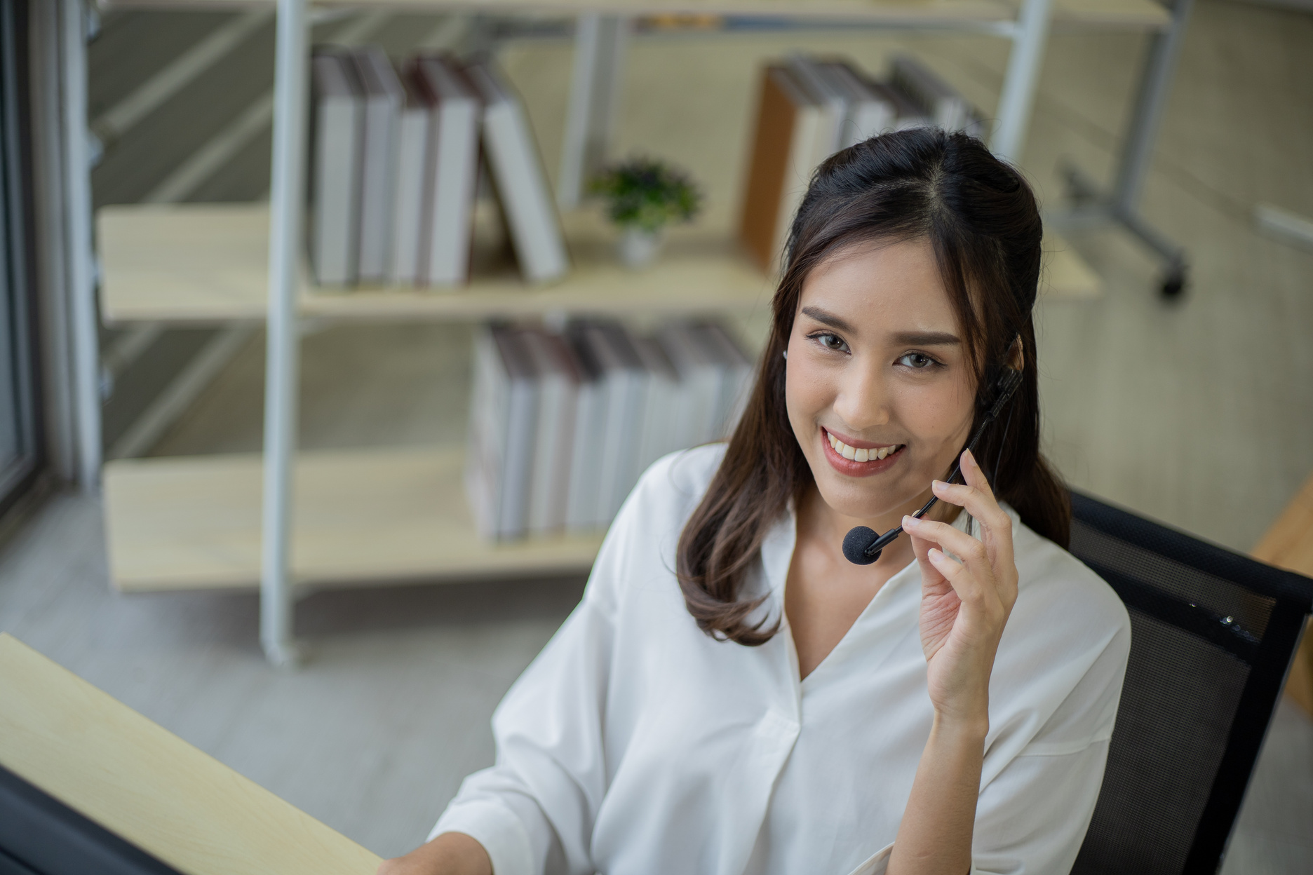 Asian telemarketing agent in call center office